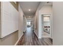 Hallway with wood-look flooring, neutral paint, and doorways leading to bedrooms at 978 Laconic Dr., Myrtle Beach, SC 29588