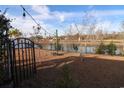 Fenced backyard with firepit, string lights, and serene pond views at 179 Springtide Dr., Conway, SC 29527