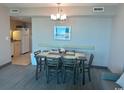 Dining area with a table and chairs adjacent to the kitchen at 2301 S Ocean Blvd. # 1002, North Myrtle Beach, SC 29582