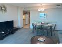 Open-concept living and dining area with a view of the kitchen at 2301 S Ocean Blvd. # 1002, North Myrtle Beach, SC 29582