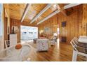 Inviting living room featuring wood paneling, exposed ceiling beams, and hardwood floors at 2306 Holly Dr., North Myrtle Beach, SC 29582