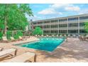 Inviting community pool surrounded by lush landscaping at 415 Ocean Creek Dr. # 2373, Myrtle Beach, SC 29572