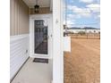 Covered front porch with a glass front door and a welcome mat at 509 Covewood Ct., Longs, SC 29568