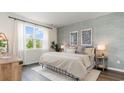 Relaxing bedroom with large windows, stylish decor, and a comfortable bed at 527 Firouz Dr, Longs, SC 29568