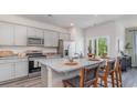 Modern kitchen with stainless steel appliances, granite countertops, and an island with bar seating at 527 Firouz Dr, Longs, SC 29568