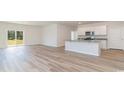 Open-concept living area with wood-look flooring and a view of the backyard at 620 Grateful Dr., Little River, SC 29566
