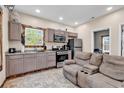 Kitchen and living area with tile floor and stainless steel appliances at 1744 Log Cabin Rd., Loris, SC 29569