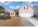 Inviting home exterior with a paved driveway and attached two-car garage at 224 Black Bear Rd., Myrtle Beach, SC 29588