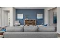 Cozy living room featuring a gray sofa, blue accent wall, and wooden furniture at 3413 Cove Side Ct., North Myrtle Beach, SC 29582