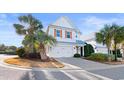 Inviting two-story home with palm trees, a paved driveway, and a well-maintained lawn at 4839 Cantor Ct., North Myrtle Beach, SC 29582