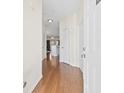 Hallway with wood-look flooring and white doors at 4924 Pond Shoals Ct. # 101, Myrtle Beach, SC 29579