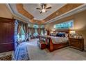 Spacious main bedroom with a tray ceiling, elegant furnishings, and access to the pool at 604 Stableford Ct., Myrtle Beach, SC 29577