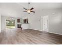 Spacious living area with wood-look floors, a ceiling fan, and access to the kitchen and dining area at 627 Snowy Owl Way, Conway, SC 29527