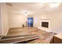 Living room with wood-look floors, fireplace, and ceiling fan at 3734 Highway 554, Loris, SC 29569