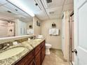 Double vanity bathroom with granite countertop and walk-in shower at 4800 S Ocean Blvd. # 611, North Myrtle Beach, SC 29582