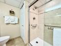 Walk-in shower with grab bars and tiled walls at 4800 S Ocean Blvd. # 611, North Myrtle Beach, SC 29582