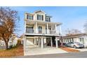 Two-story house with a large deck, attached garage, and ample parking at 6001 - 5326 S Kings Hwy., Myrtle Beach, SC 29575