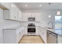 Bright, spacious kitchen featuring white shaker cabinets, stainless steel appliances, and granite countertops at 604 Asiago Dr., Myrtle Beach, SC 29579