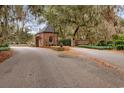 Gated entrance to Wedgefield Plantation, showing a brick guardhouse and paved road at 291 Frances Parker Rd., Georgetown, SC 29440