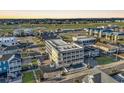 Aerial view showcasing building, pool, and surrounding neighborhood at 301 N Waccamaw Dr. # 109, Garden City Beach, SC 29576