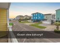 Ocean view from balcony, showcasing beach and neighborhood at 301 N Waccamaw Dr. # 109, Garden City Beach, SC 29576
