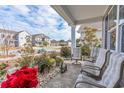 Relaxing front porch with rocking chairs, overlooking the neighborhood at 405 Cypress Springs Way, Little River, SC 29566