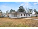 Front view of a renovated white brick ranch house at 412 E Melrose St., Mullins, SC 29574