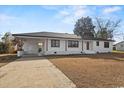 Front view of a renovated white brick ranch house at 412 E Melrose St., Mullins, SC 29574