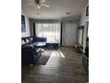 Living room with gray walls, hardwood floors, and sectional sofa at 4401 Hunting Bow Trail, Myrtle Beach, SC 29579