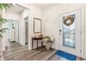 Bright entryway with hardwood floors and a decorative console table at 4551 Day Lily Run St., Myrtle Beach, SC 29579