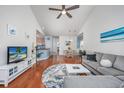 Open living space with hardwood floors, sectional sofa, and dining area at 5804 Longwood Dr. # 301, Murrells Inlet, SC 29576