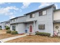 Light blue townhome with red door and walkway at 775 Plantation Dr. # 59, Little River, SC 29566