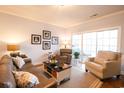 Spacious living room with leather sofas and sliding glass doors at 4161 Hibiscus Dr. # 203, Little River, SC 29566