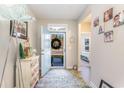 Bright entryway with light blue door, decorative rug, and built-in storage at 5037 Sassari St., Myrtle Beach, SC 29579