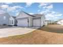 Two-car garage with light gray siding and two white garage doors at 5037 Sassari St., Myrtle Beach, SC 29579