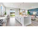 Modern kitchen with white cabinets, island, and view to backyard at 531 Slaty Dr., Myrtle Beach, SC 29588