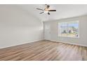 Bright and spacious living room featuring hardwood floors and a large window at 637 Woodside Dr., Conway, SC 29526