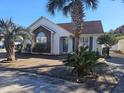 House exterior with palm trees and a brick walkway at 927 Edge Dr., North Myrtle Beach, SC 29582