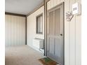 Private condo entrance with exterior door and small window at 9501 Shore Dr. # D-235, Myrtle Beach, SC 29572