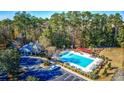 Community pool with lounge chairs, clubhouse, and playground at 15 Melbourne Ct., Murrells Inlet, SC 29576