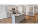 Modern kitchen with gray cabinets, granite countertops, and island at 1522 Clubstone Dr., Conway, SC 29526