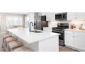 Modern kitchen with white cabinets, stainless steel appliances, and an island at 2341 Elowen Ln. # 11E, Longs, SC 29568