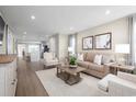 Spacious living room with beige sofa and hardwood floors at 2341 Elowen Ln. # 11E, Longs, SC 29568