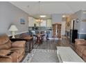 Open concept dining area with a wooden table and chairs near kitchen at 4717 Wild Iris Dr. # 29-303, Myrtle Beach, SC 29577