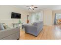 Living room with gray sofa and sliding door to patio at 4823 Innisbrook Ct. # 703, Myrtle Beach, SC 29579