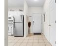 View of entryway, kitchen, and stainless steel refrigerator at 5801 Oyster Catcher Dr. # 324, North Myrtle Beach, SC 29582