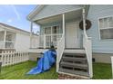 Front porch view of a light blue house with white railing and steps at 815 Rogers Dr., Myrtle Beach, SC 29577