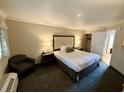 King-size bed, armchair, and access to closet and bathroom at 1105 S Ocean Blvd. # 334, Myrtle Beach, SC 29577