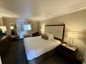 King-size bed, nightstands, and a comfortable armchair at 1105 S Ocean Blvd. # 334, Myrtle Beach, SC 29577