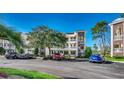 Two-story condo building with ample parking and landscaping at 1192 River Oaks Dr. # 28-B, Myrtle Beach, SC 29579